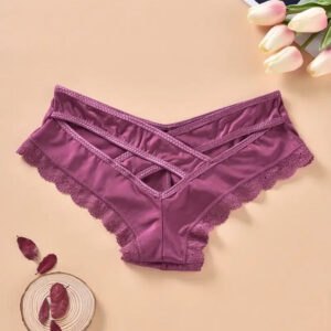 Purple lace underwear on a beige background with flowers and leaves.