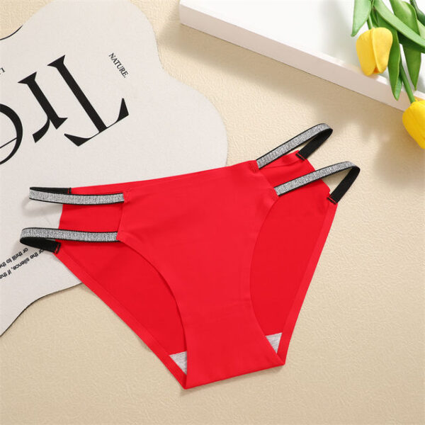 Red underwear with gray straps on a beige surface