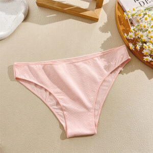 Pink women's underwear on a light surface with a minimal background