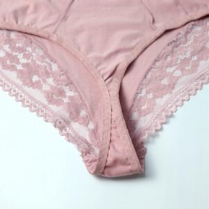 Pink lace-trimmed underwear on a light gray background