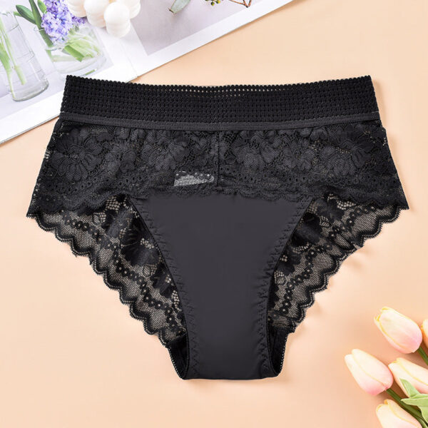 Black lace underwear on a beige background with flowers.